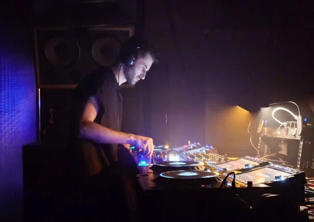 Joseph Nakouzi in the booth, purple club lights
